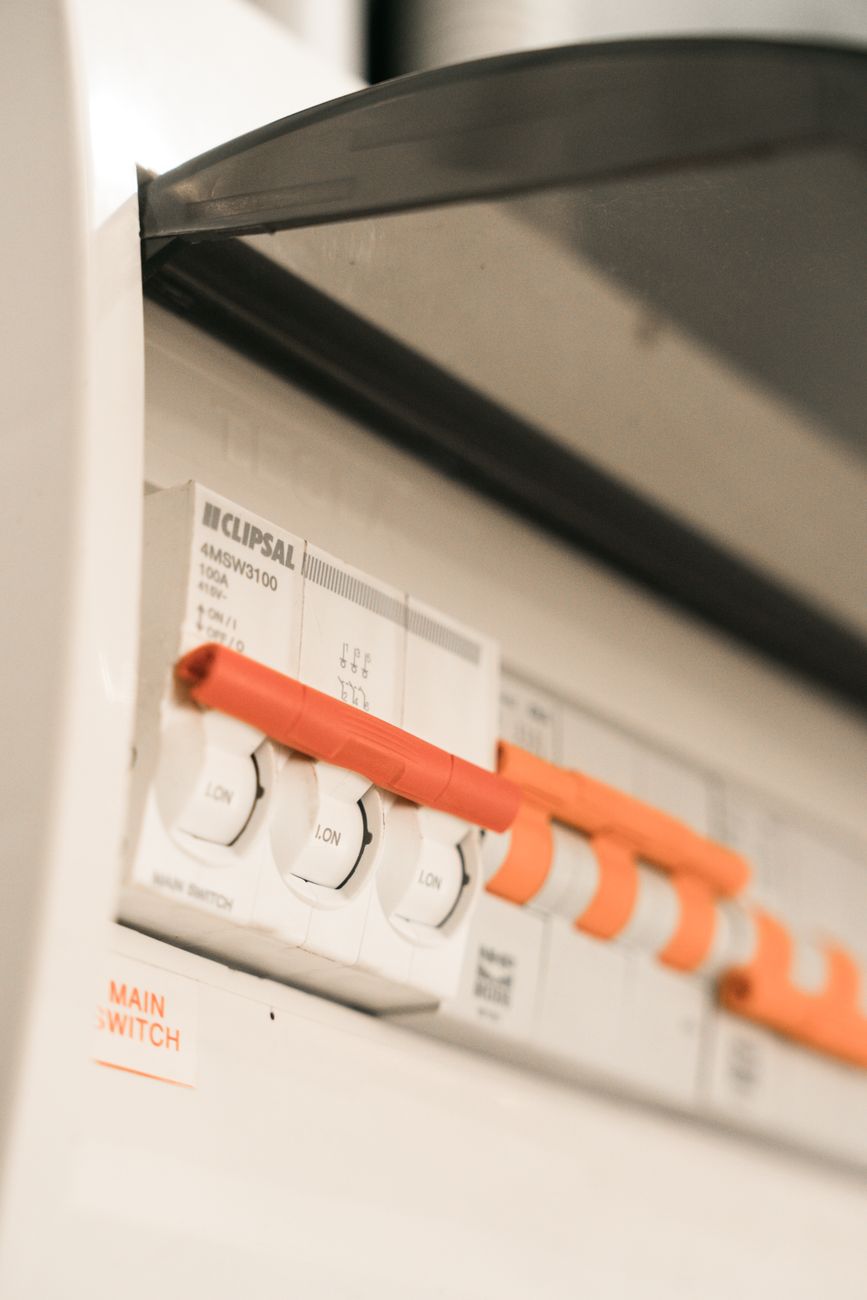Electrician testing a breaker panel in a bright modern home
